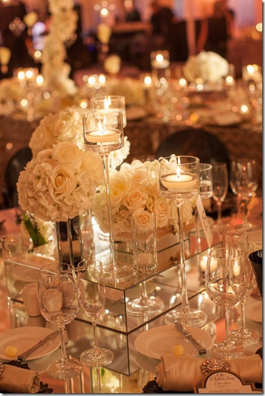 white roses and high candles wedding centerpiece